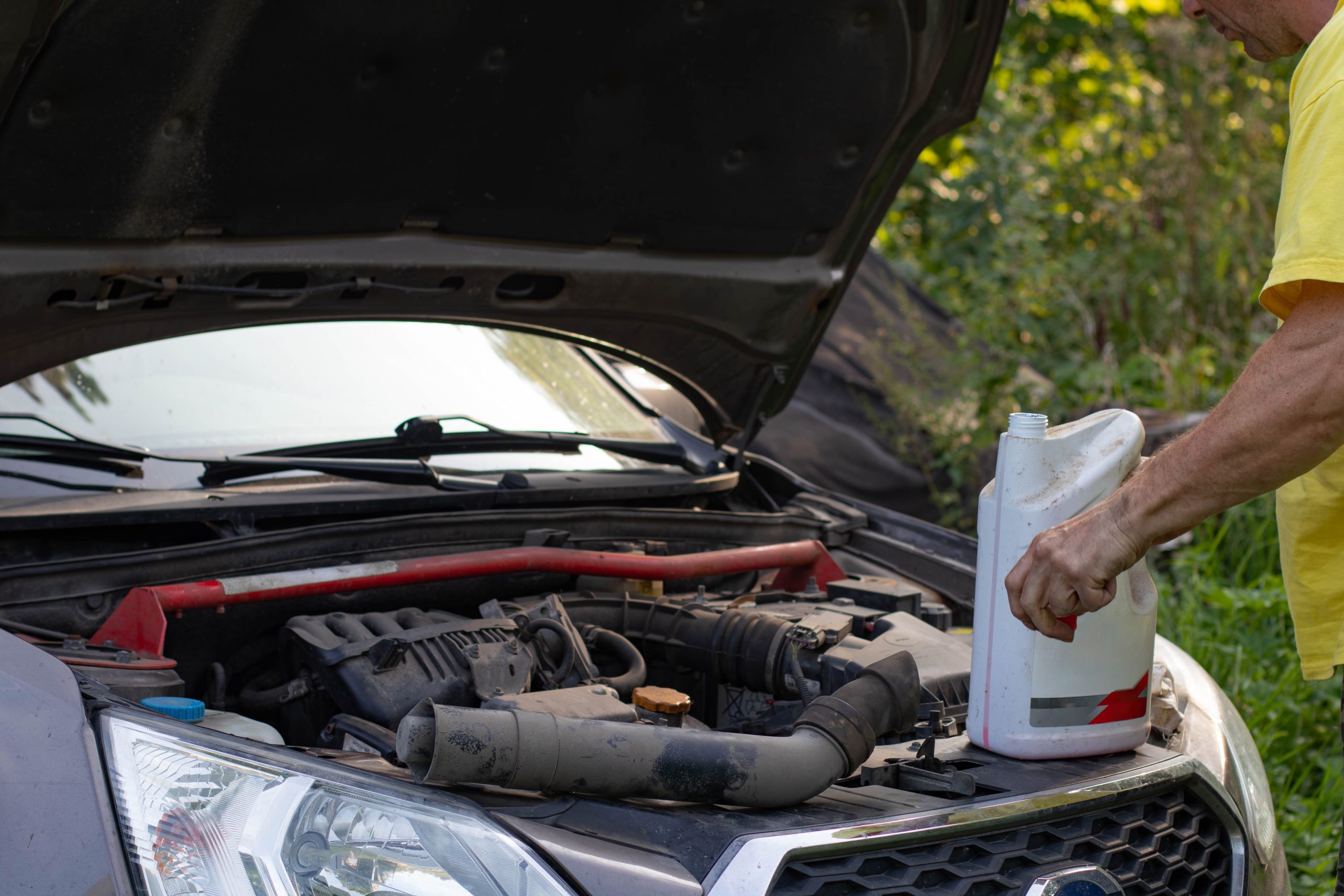 A mechanic connecting a diagnostic scanner to an OBD-II port