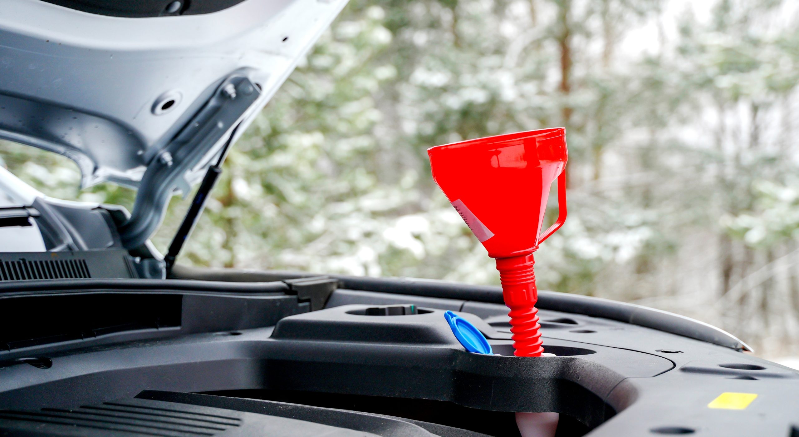 Close-up of a coil-on-plug ignition coil being removed from an engine