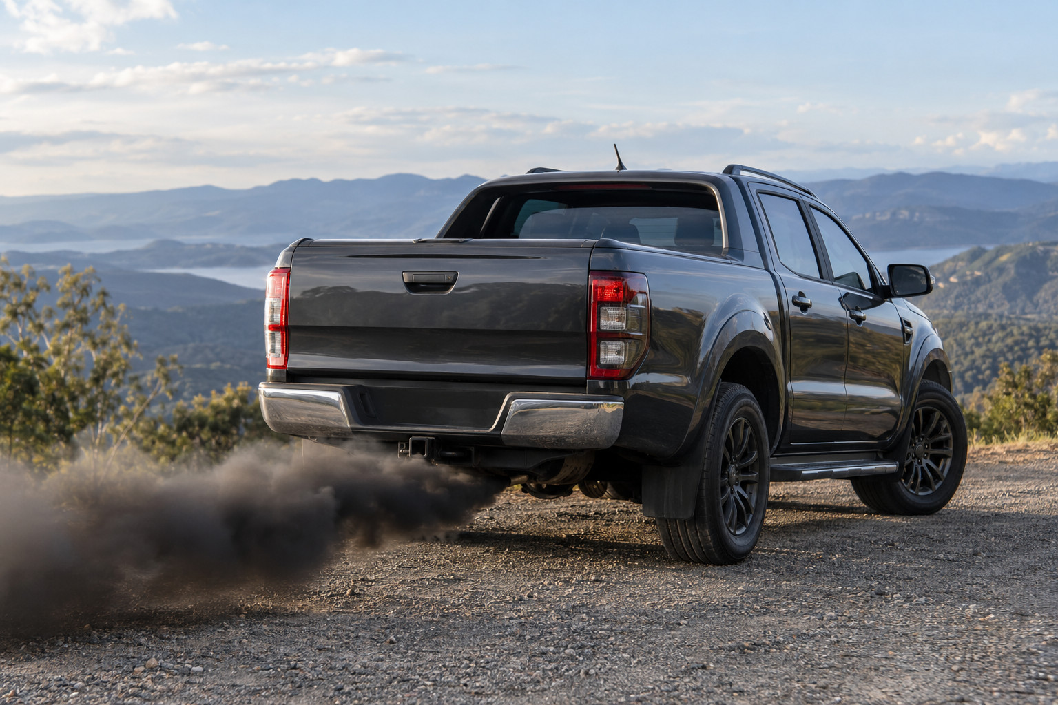 Black smoke from the exhaust of a contemporary diesel ute outdoors